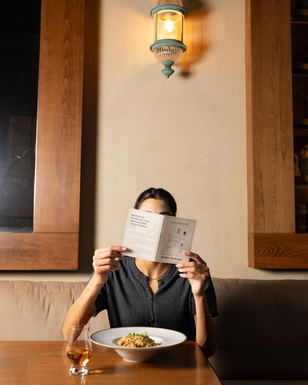A person browses a menu at The Townhouse in Beirut