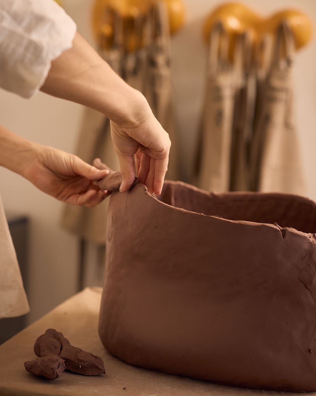 Rika Kova building a clay pot in her Scottsdale studio