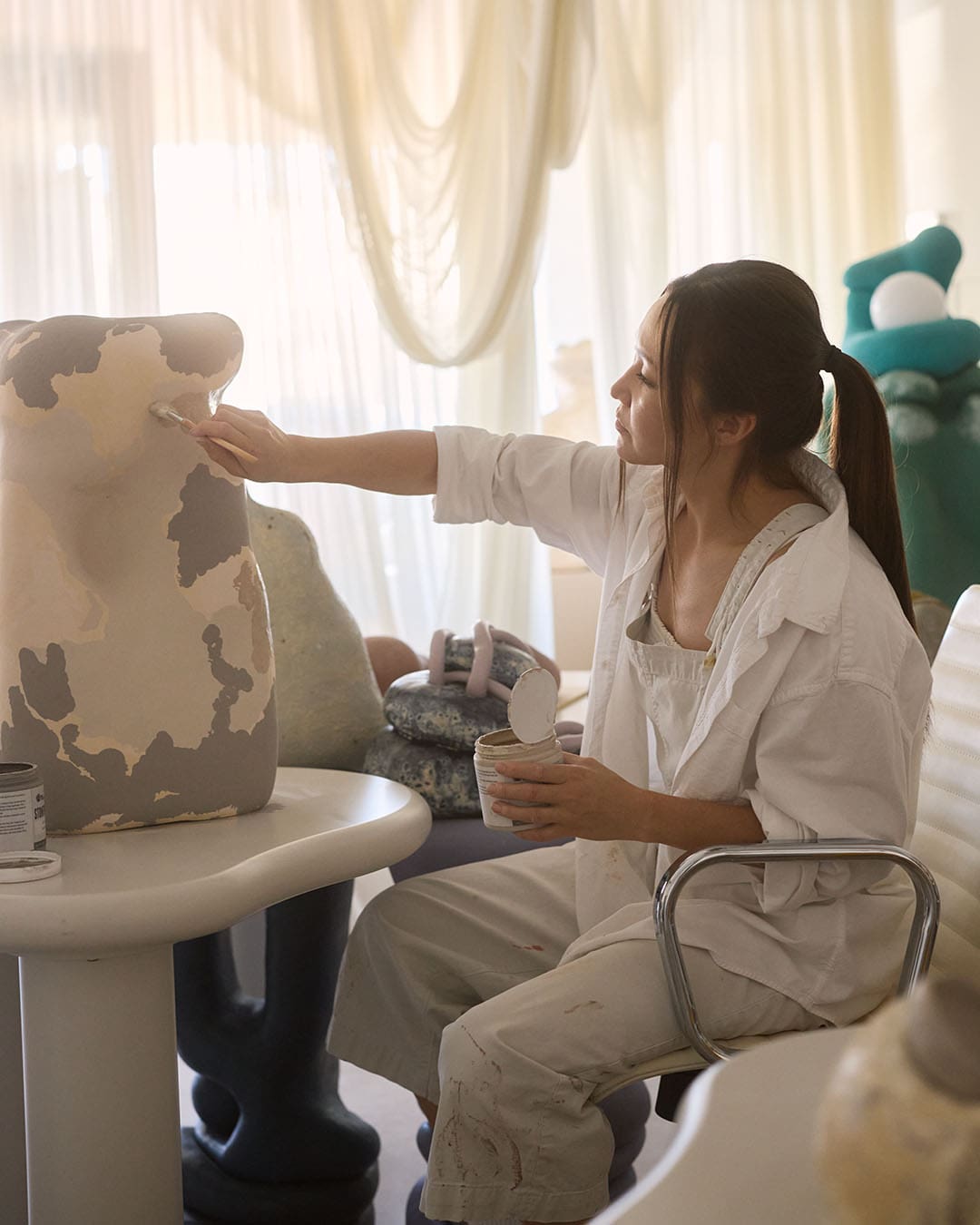 Rika Kova building a clay pot in her Scottsdale studio