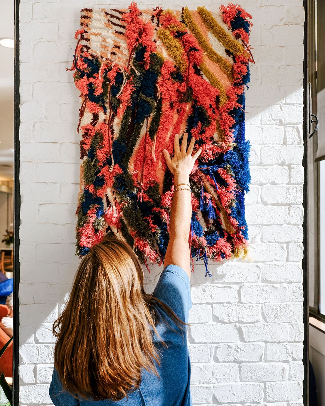 Trish Andersen puts tghe finishing touches to her work on display at Andaz Savannah