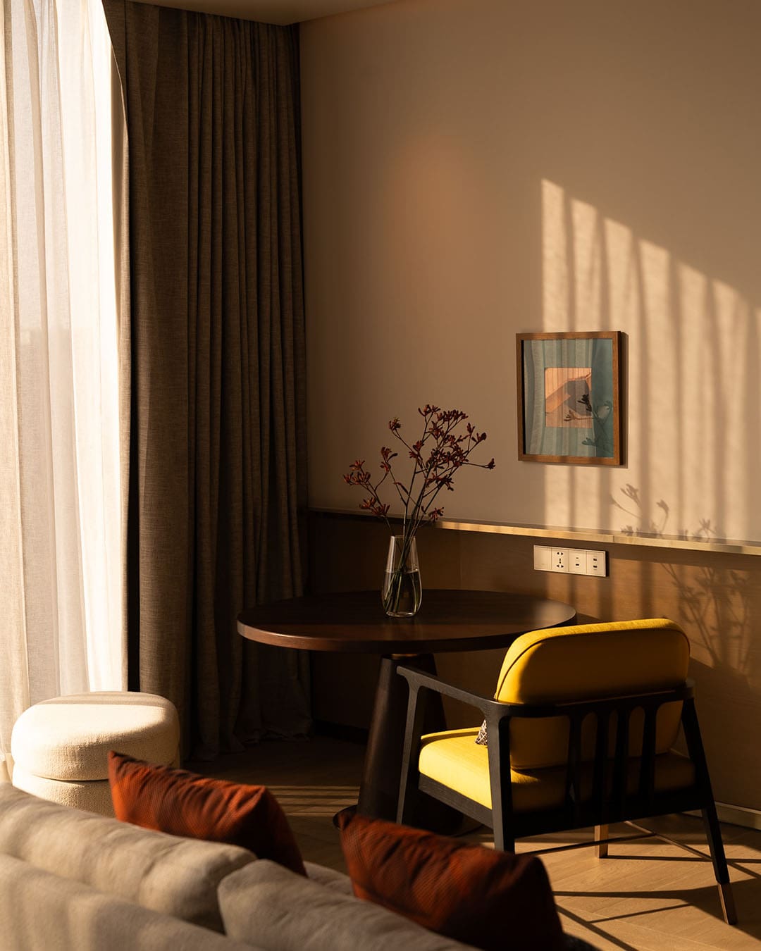 Room detail at Andaz Bangkok, featuring a cushioned chair and light streaming through a window
