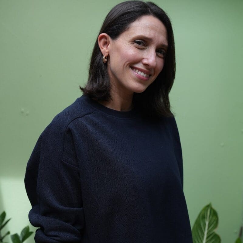 Profile photo of writer Megan Leon against a green backdrop