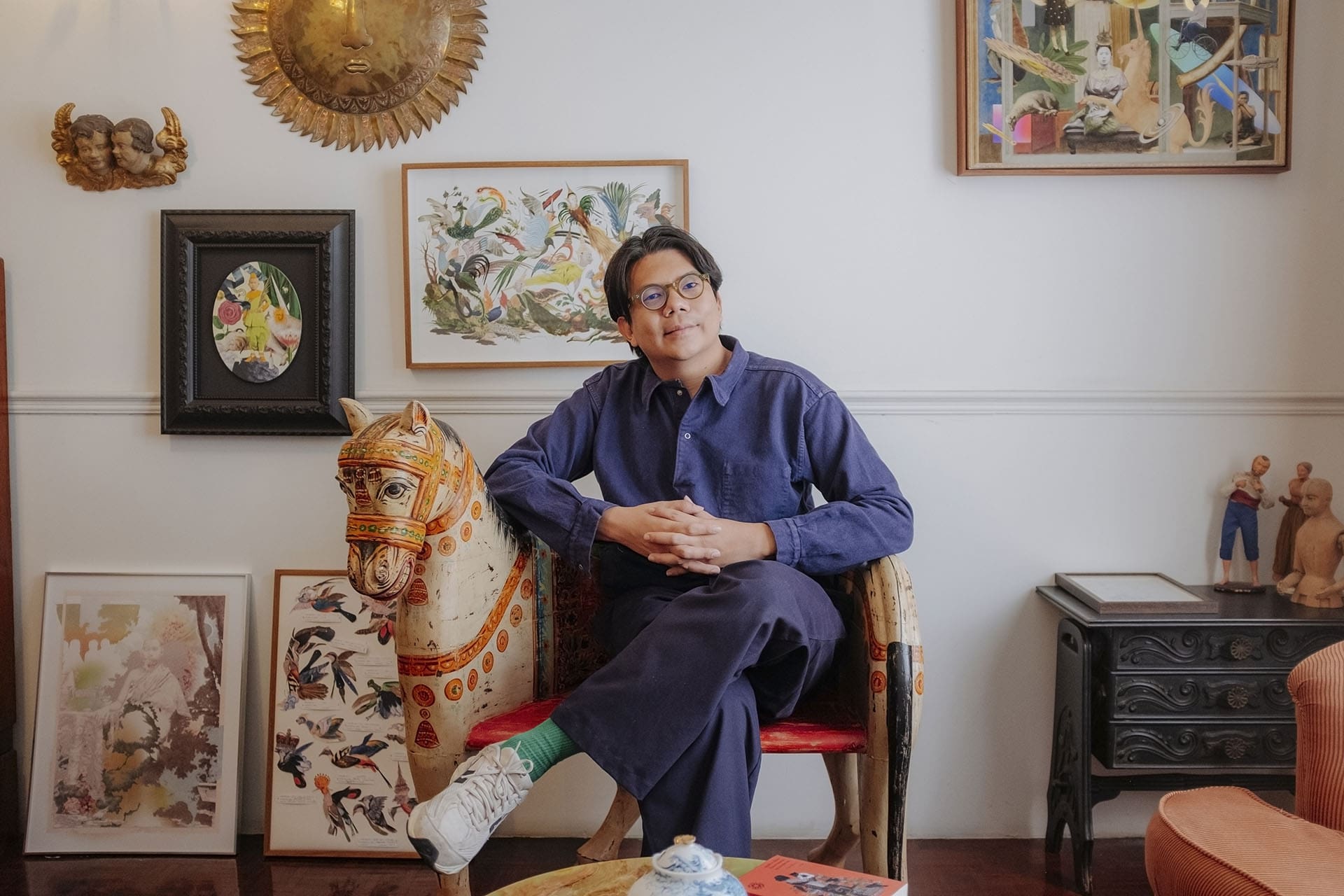 Nakrob on a horse-shaped seat in his Bangkok studio. Photography by Adam Birkan