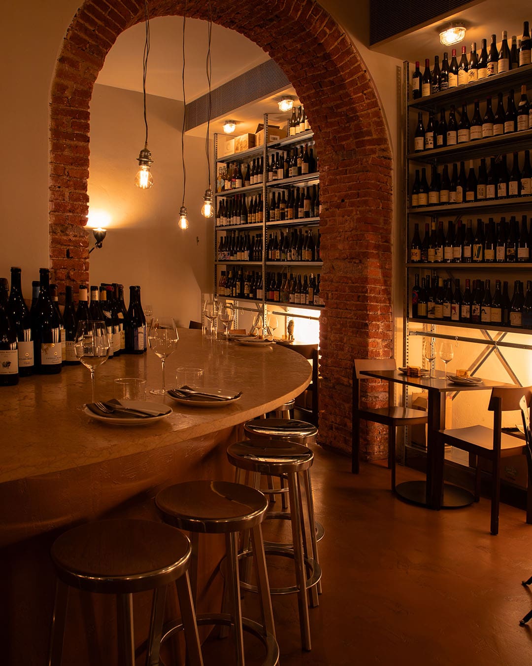 Brick walls lined with bottles at Deposito Enoteca wine bar