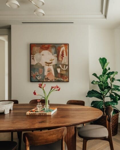 An oak dining table by a painting at Claridge House by SLO, London