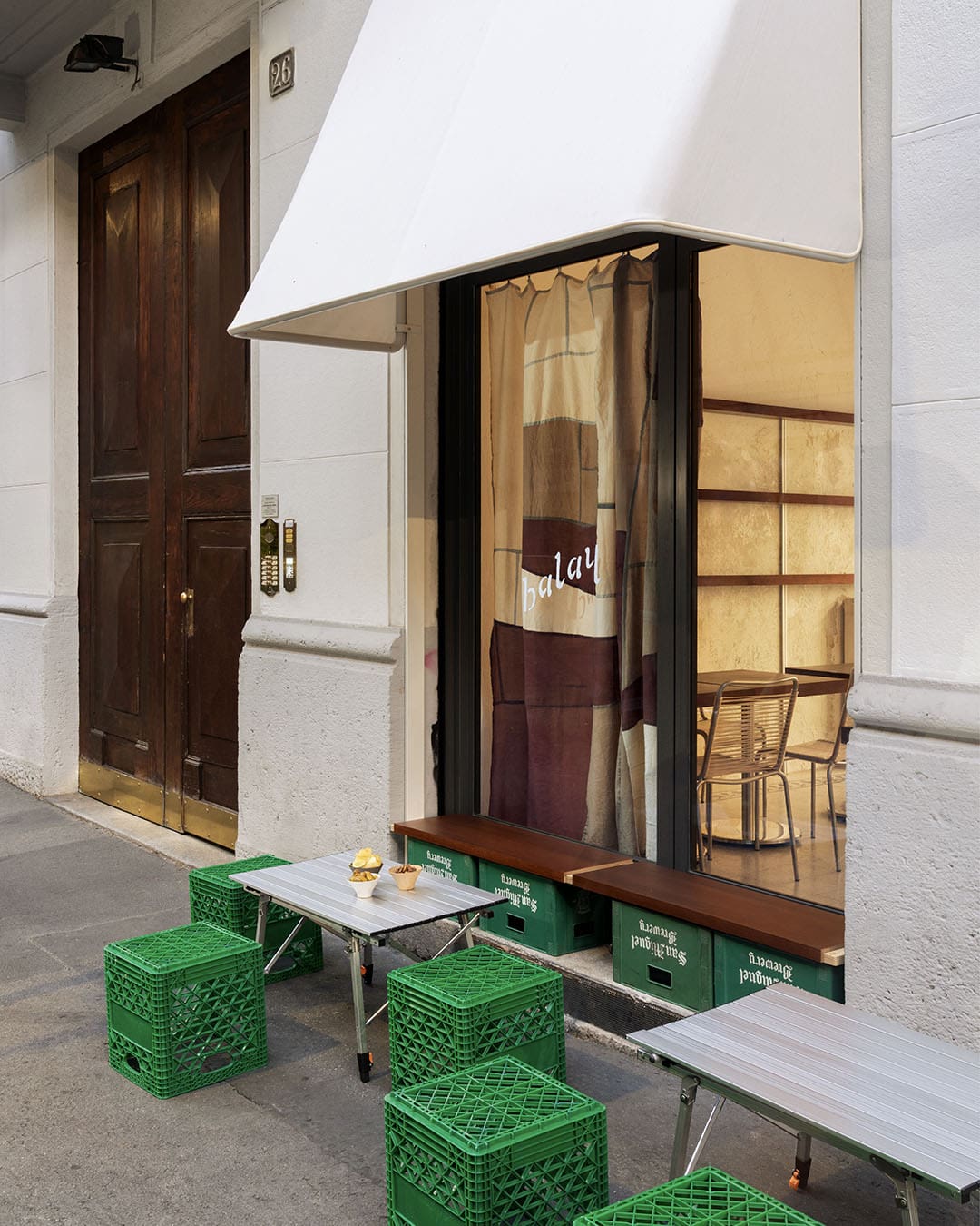 Bright green brewery crates outside Balay in Mian