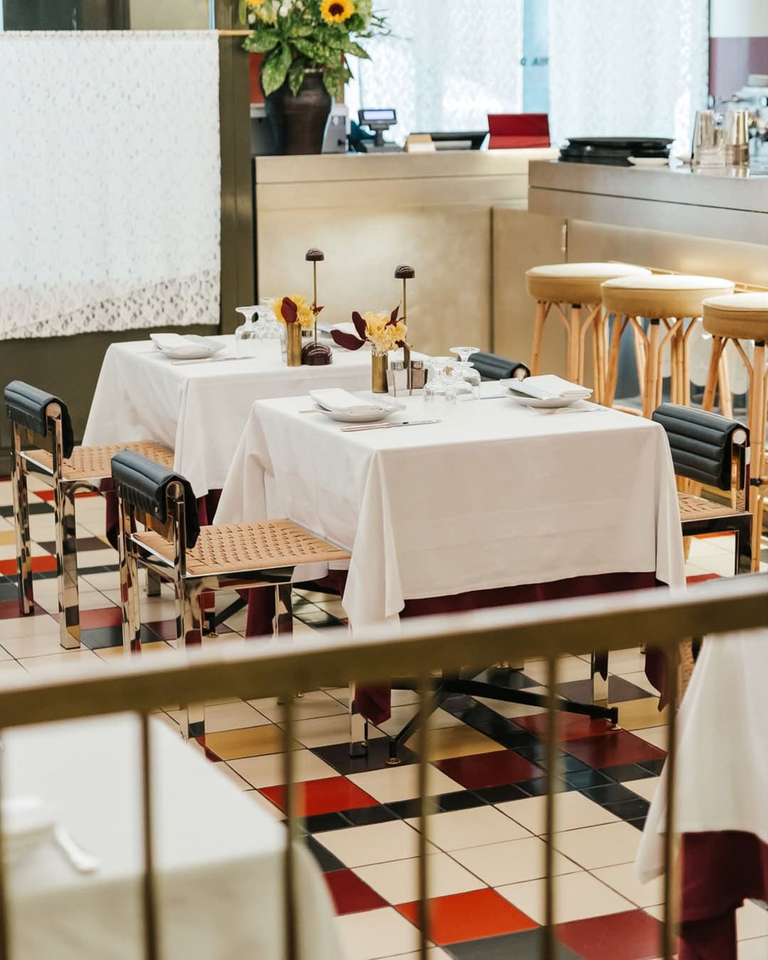 Retro charm at Trattoria del Ciumbia, with graphic tiles and white tablecloths in view