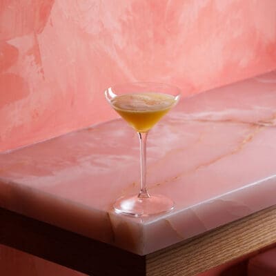 Cocktail photographed on pink background, in Le Tigre, a bar in Toronto