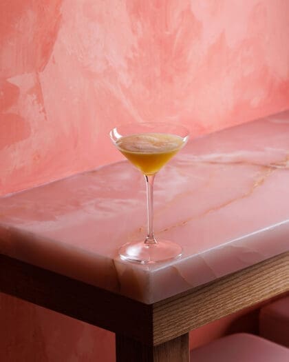 Cocktail photographed on pink background, in Le Tigre, a bar in Toronto