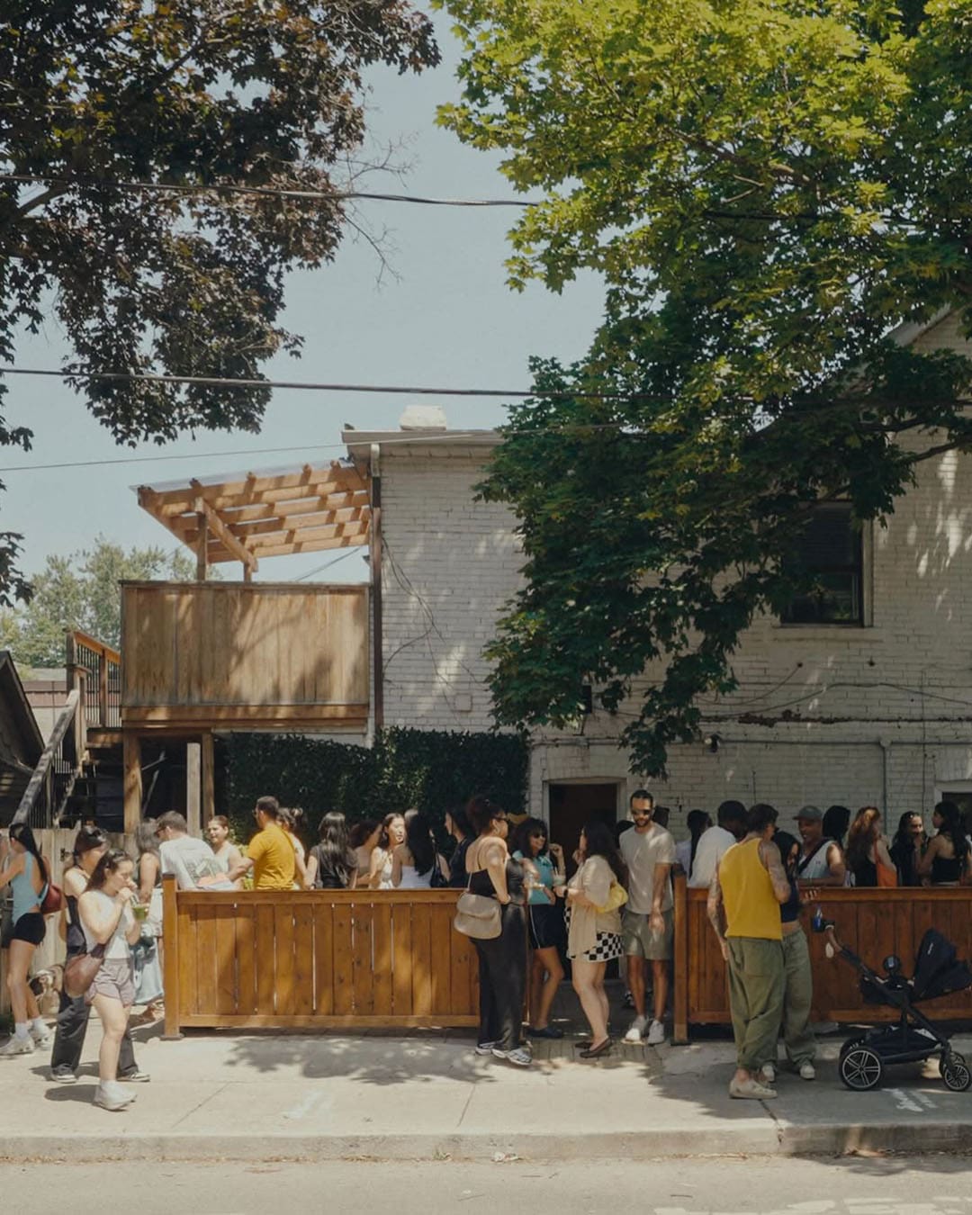 A group of customers enjoy an evening event outside The Sonndr Cafe in Toronto