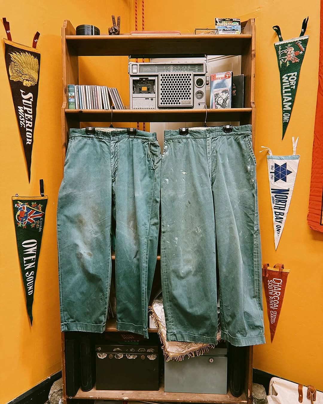 Clothing at Exile Vintage with yellow wallpaper and flag pennets on the wall